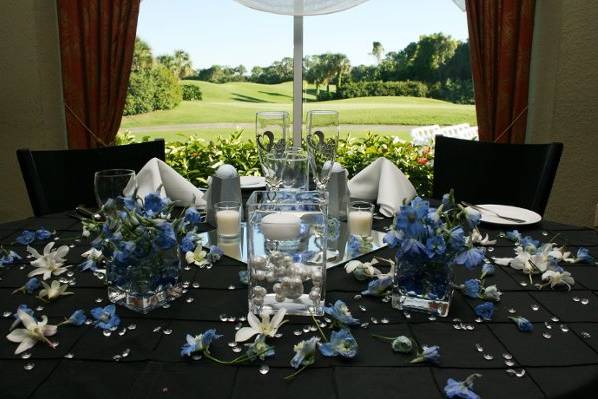 Black table setup with blue flowers