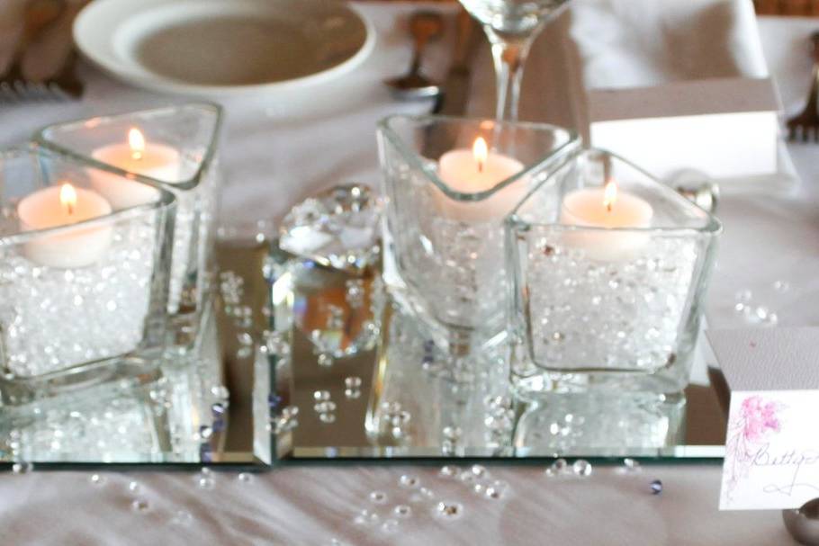 Clear diamond confetti and candles on mirror