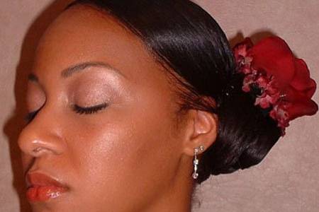 Neat pulled back hair with flower accessory