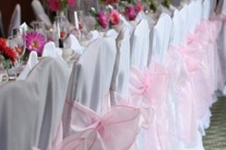 White chaircovers & pink sashes