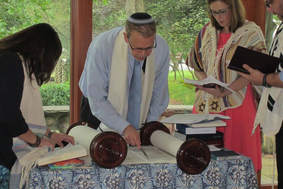 Officiant opening a scroll