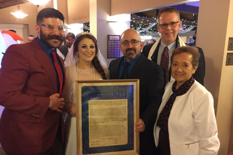 Holding a framed certificate