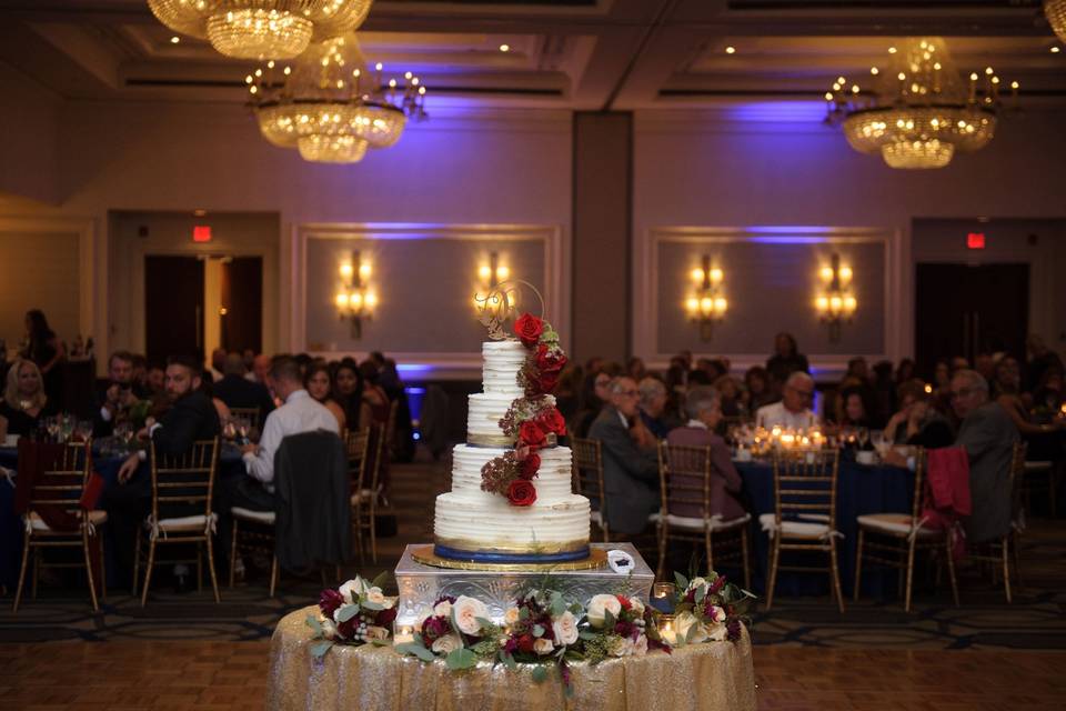 The cake with red flowers on display