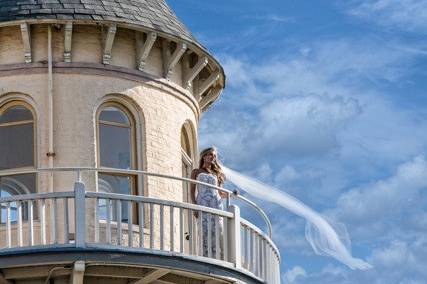 Bride on the presidential suite balcony of the hotel's turret