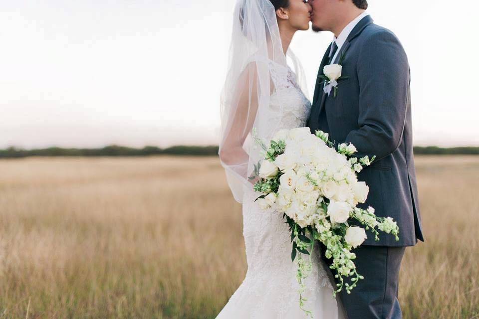 Bride @ Groom sweet kiss in the meadow.