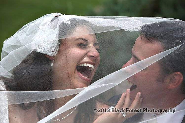 Candid laughing photograph of the bride and groom