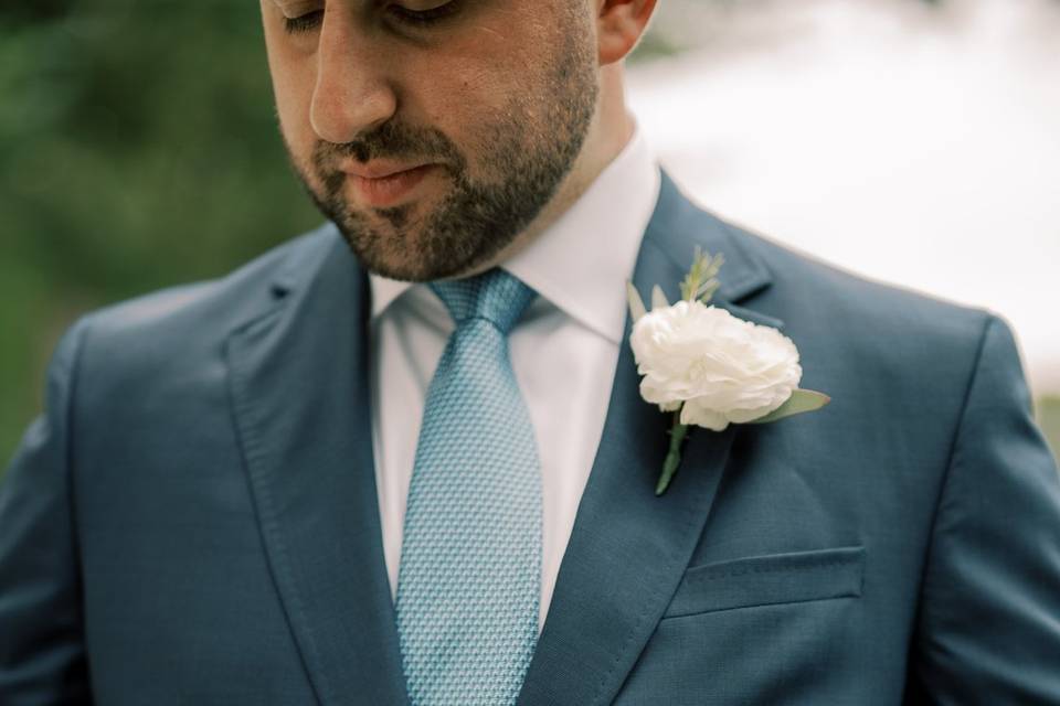 Groom buttoning suit
