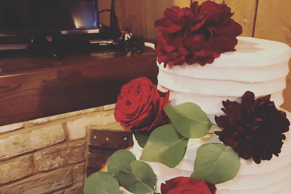 Decorating cakes with flowers is an amazing skill for a wedding planner to have! This absolutely cannot be left to just anyone. This is a cake jenna decorated at rustic manor 1848.