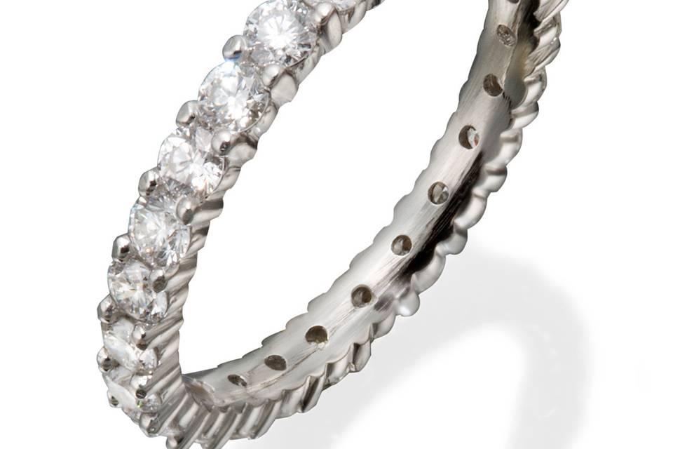 A lady's classic eternity band with round diamonds in shared prong settings.