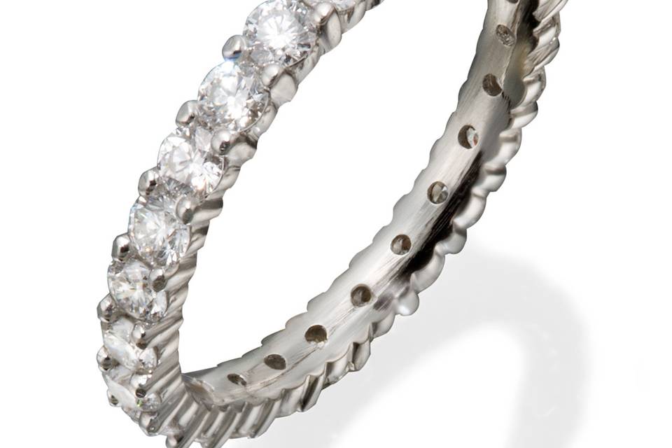 A lady's ultra thin classic eternity band with round diamonds in shared prong settings.