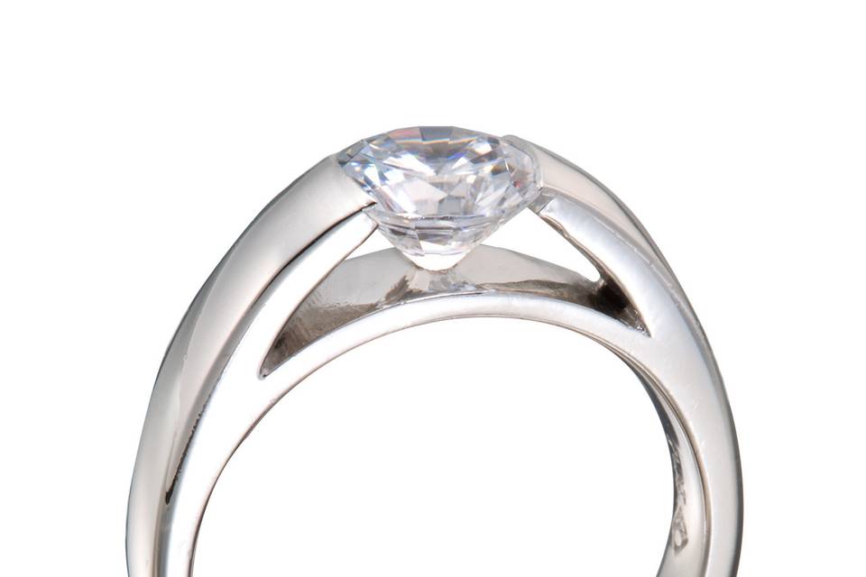 A highly modernized diamond engagement ring with a round diamond in a 