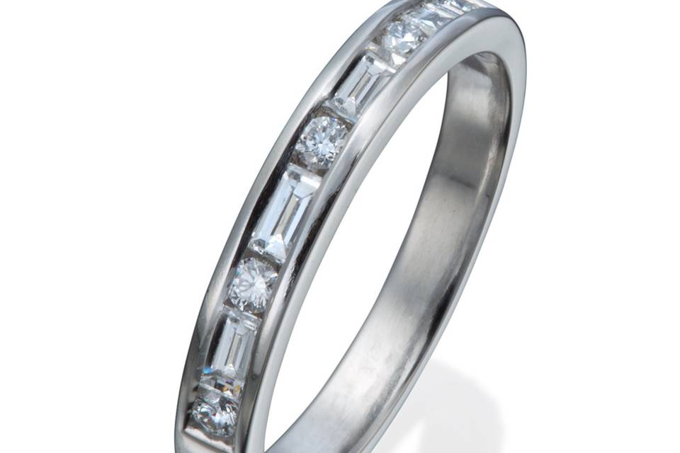 A lady's modern diamond wedding band with both round and straight baguette diamond accents.