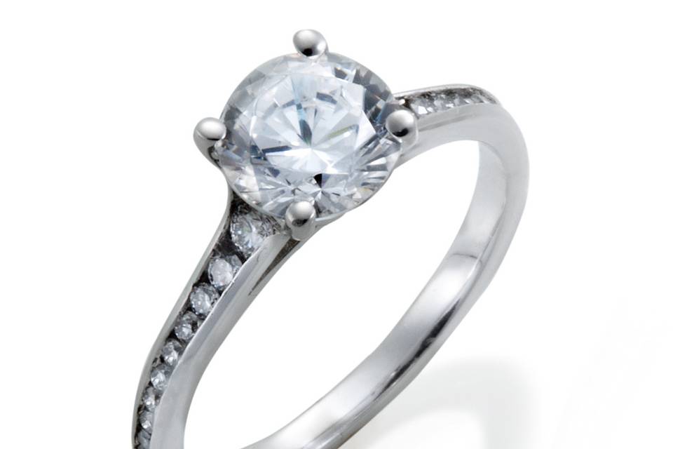A classic diamond engagement ring with channel set round diamond accents of graduated sizes.