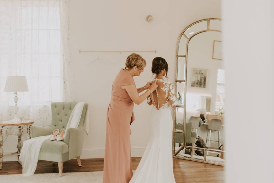 Putting on her wedding dress