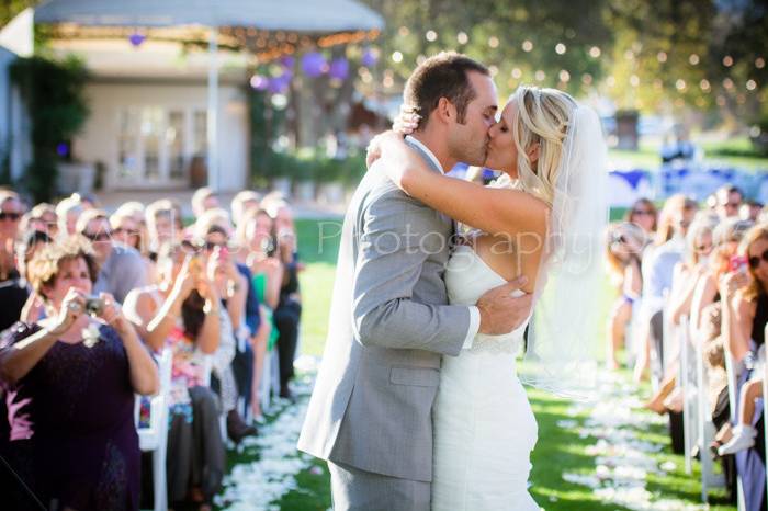 Couple take a moment to share a kiss during their reception.