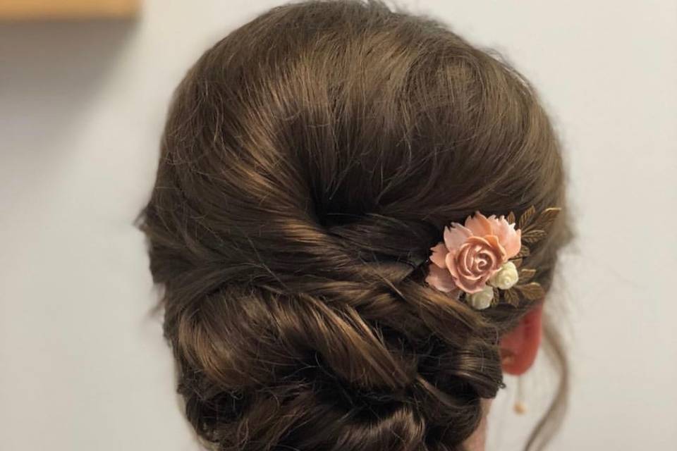 Updo with floral hair piece