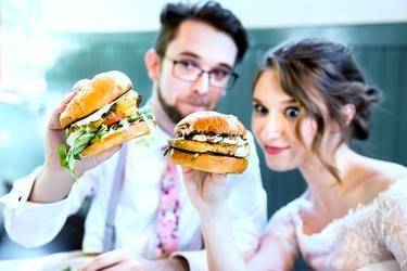 Newlyweds eating burgers
