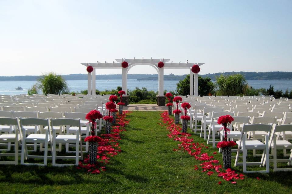 Roses, roses, roses!  Topiary balls on arbor, topiary forms and petals line the aisle - beautiful!