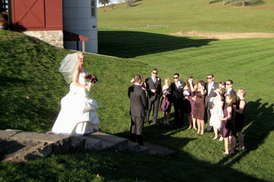 Beautiful historic barn and farmland makes a great backdrop to this wedding ceremony.