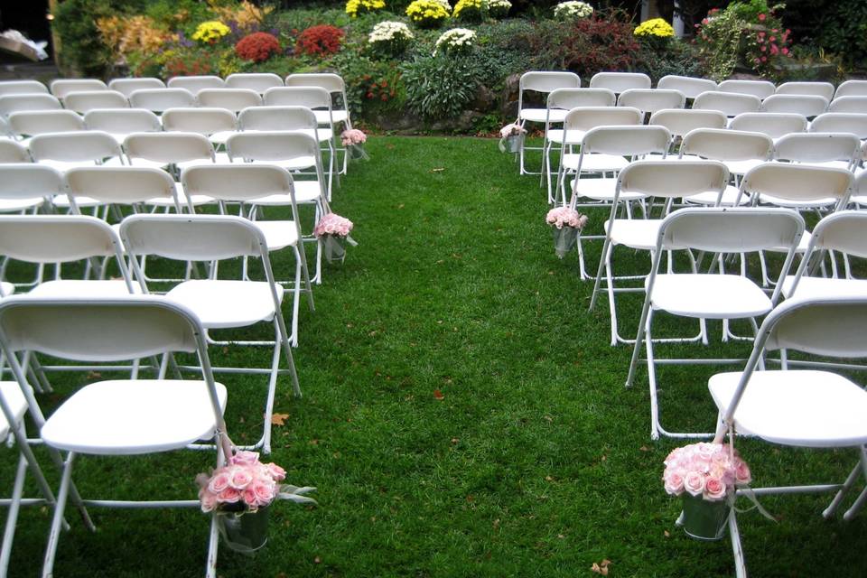 Matched floral displays on pedestals frame the landscape background.