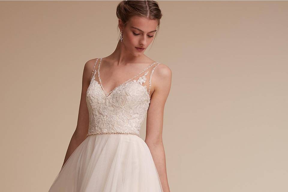 BHLDN Cassia Gown		Trimmed in sparkle, this effortless v-neck gown exudes romance. Intricate illusion lace, replete with glistening beads, ascends from the bodice and a frothy tulle skirt finishes the look. A bonus: pearl buttons down the back!