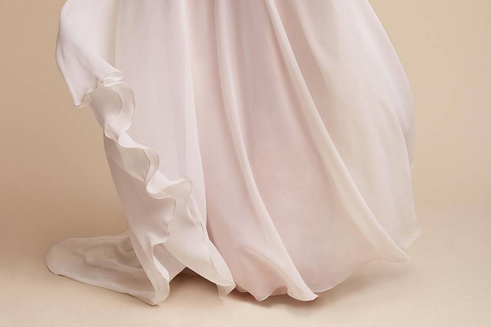 BHLDN Taryn Gown		Delicate lace traverses the bodice of this romantic gown, framing a dramatic v-neck and back. Blush lining peeks out from beneath for an illusory effect while a soft ivory chiffon skirt brings cloud-like movement.