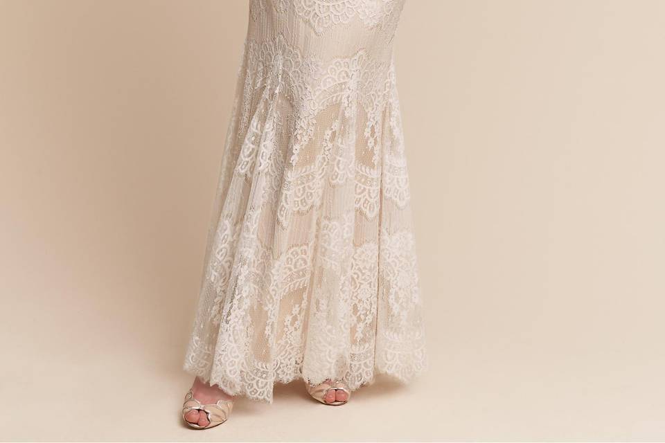 Catherine Deane	BHLDN Suri Gown	<br>	Fitted through the bodice and hips, this gown exudes femininity. Illusion lace at the décolletage frames the face, leading to a beautiful open back. Scalloped bands of vintage-inspired lace create a motif we find most alluring.