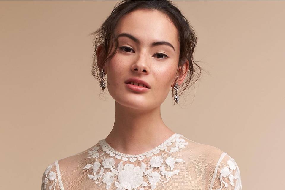 Catherine Deane	BHLDN Jessica Bodysuit	<br>	An illusion bodysuit is a sophisticated way to create a layered bridal look, especially when it's embellished with graphic floral appliqué. Satin-covered buttons provide an elegant finish to the back.