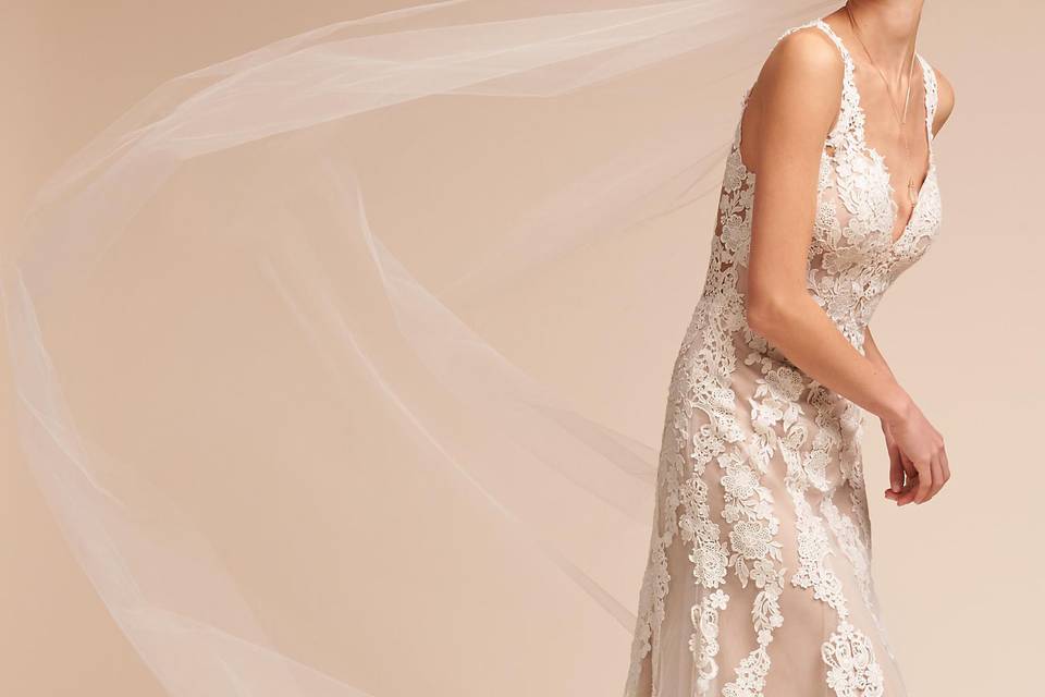 BHLDN	BHLDN Monarch Gown	<br>	We love how floral lace appliqué floats down airy, raw-edge tulle, but our favorite detail is the stunning illusion back with a long row of covered buttons. A sweeping train provides a romantic finish.