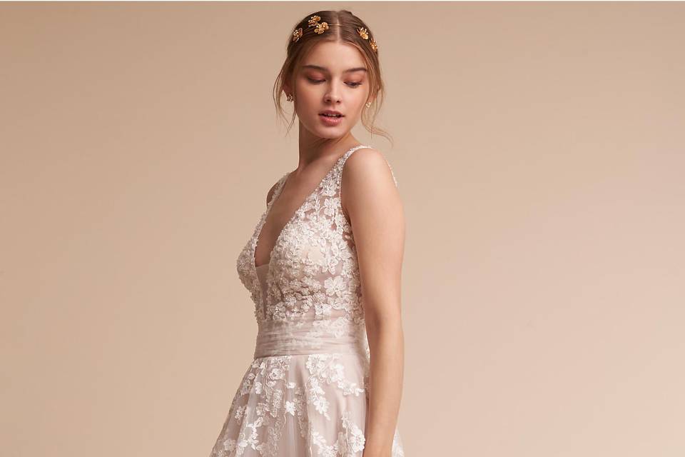 Eddy K	BHLDN Radcliffe Gown	<br>	Breathtaking from every angle, we’re in love with this A-line gown’s wide, open back and dramatic train. Crystal-embellished lace appliqué covers the fitted bodice then cascades down the ethereal tulle skirt, bringing subtle sparkle and a decidedly romantic air. A row of satin buttons finishes the look.