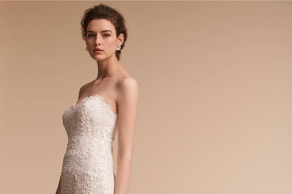 Willowby by Watters	BHLDN Inez Gown 	<br>	Covered entirely in delicate lace appliqué, this slim gown has a softly flared skirt, plunging back with scalloped detailing, and thin spaghetti straps