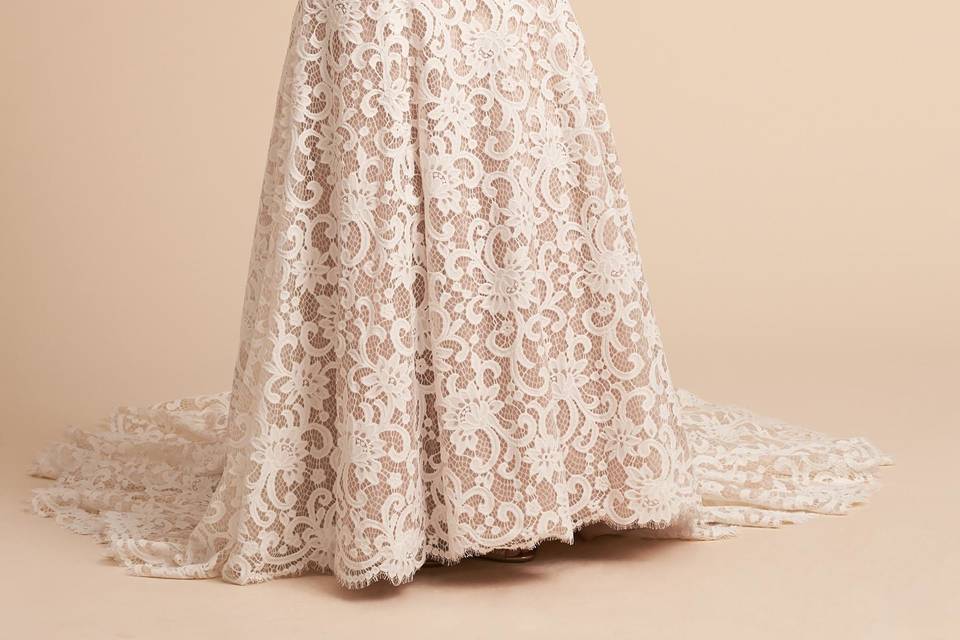 WTOO by Watters	BHLDN Pippin Gown	<br>	Vintage-inspired with a decidedly modern appeal, this slim gown stands out with bold, geometric lace embellished with lustrous beads. We love the sultry low back (stacked with a row of satin-covered buttons) and the flared skirt falling to the floor in a dramatic train.