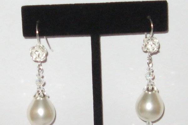 Mother of Pearl, Pearls these drop look better than the real thing. Sterling Silver bead caps and Swarovski crystal.