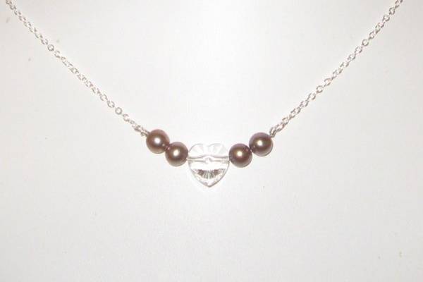 Fresh water pearls in the dyed Taupe shade with a clear Swarovski heart.