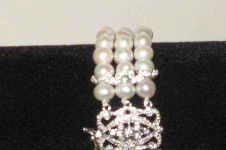 Beautiful fresh water pearl and rhinestone triple strand bracelet.  This bracelet was designed and created by Ms Foster.  I purchased it from her, she will no longer be creating bridal jewelry.  This is a new bracelet, not used.