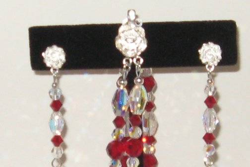 Brides maids bracelet and earrings set. Notice the rose made of Sterling silver on the bracelet and all of the crystal is Swarovski.  Also on the earrings, just not as noticeable.