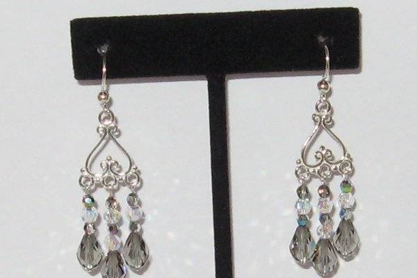 Sterling silver with black diamond and clear A.B. SWAROVSKI crystals.  There is no limit to the crystals but the chandelier would have to be changed.  The one shown is no longer made.  Great look for the pewter bridesmaids dresses.