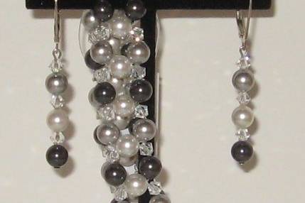 SWAROVSKI  crystal and pearls.  The pearls in shades of black, light grey (silver) and white. This is not a one only and can be recreated in as many as desired.  A great after the wedding set.  The metal sterling silver.