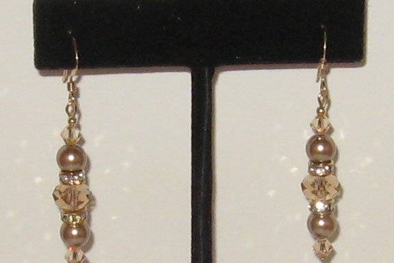 SWAROVSKI crystal in the Colorado topaz and bronze shade of pearls.  14 kt gold filled ear wires.  Great for the shades of a darker taupe dress or gown.  There is no limit to the amount that can be made of this earring.