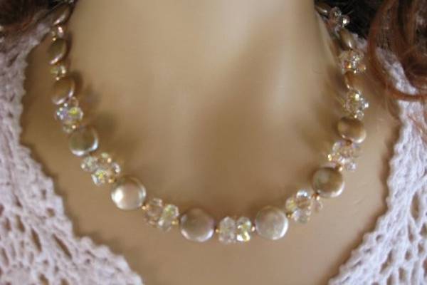 AAA's Champagne shade of coin pearls.  The crystal SWAROVSKI is a newer shape.  Each grouping is a series of three together.