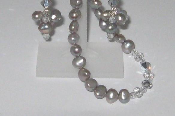 Baroque pearls in a beautiful silver shade.  SWAROVSKI crystal in a clear and new shade that has a silver finish on one side.  Sterling silver clasp with rhinestones.
