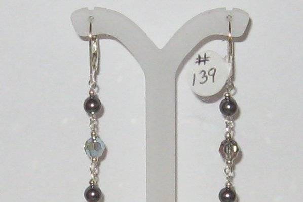 SWAROVSKI crystal and pearls.  Pearls in the dark grey shade.  Sterling silver findings.
This pair is named Kristen.