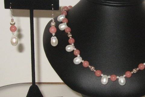 Malaysian jade in the salmon shade.  Rice pearls in the 9 mm size that are side drilled. accent with sterling silver beads.  This was designed not to lay rounded but square at the neckline.