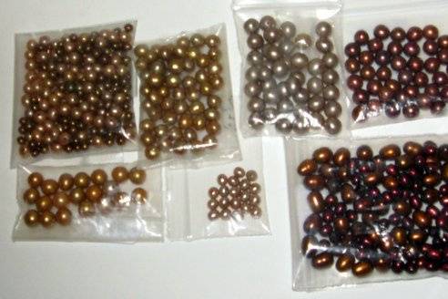 Tans, taupes, browns, rust and cranberries fresh water pearls.