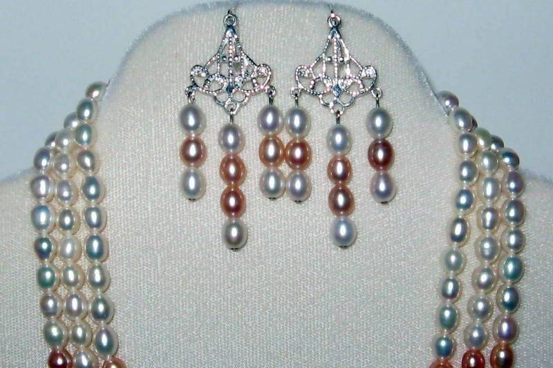 Three strand necklace and chandelier earrings.  Fresh water pearls in a dark peach shade.  The new color for this year.  This is a one and only strand.  The true color for this set is in the 3rd of the pics.