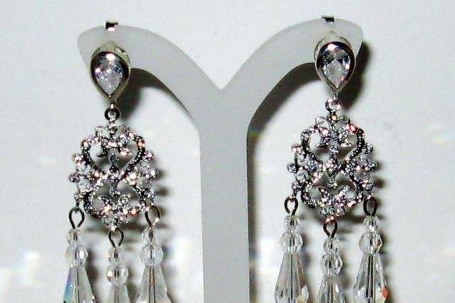 Rhinestone rhodium plated chandelier base with, Swarovski crystal spears and drops.  The earring posts have a pear shaped CZ in them. The earring posts are sterling silver.