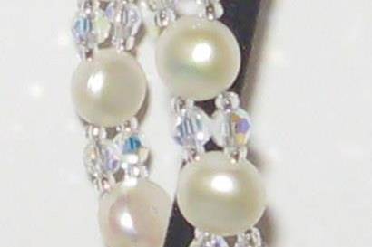 Button pearl bracelet with crystal in between. Sterling silver clasp, with CZ.