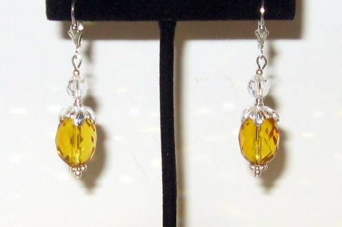 Beautiful faceted citrine ovals. Fancy sterling silver bead caps and lever backs. These are not the color but the gemstone itself. A little bit of Swarovski crystal on top.