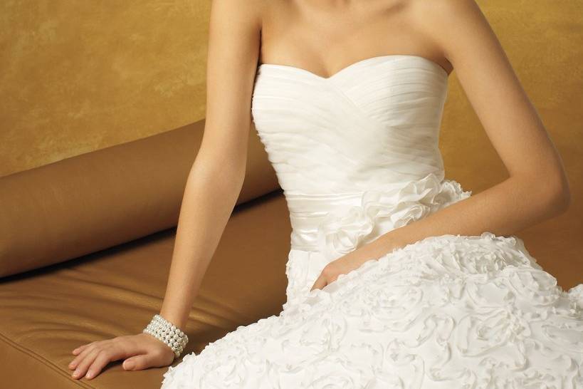 5078WStrapless chiffon wedding dress with a shirred empire waist and ribbon rosette skirt.