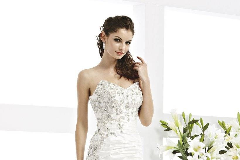 41770-VR61060This strapless taffeta wedding dress is detailed with corset tie back, metallic threading, and beaded lace appliques.